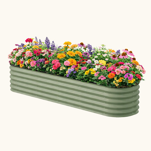 Green metal planter filled with colorful flowers on a white background